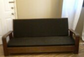 Antique colonial wood couch with cushions